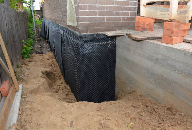 SJ Waterproofing Pros technician performing targeted Basement Waterproofing assessment in East Northport, NY